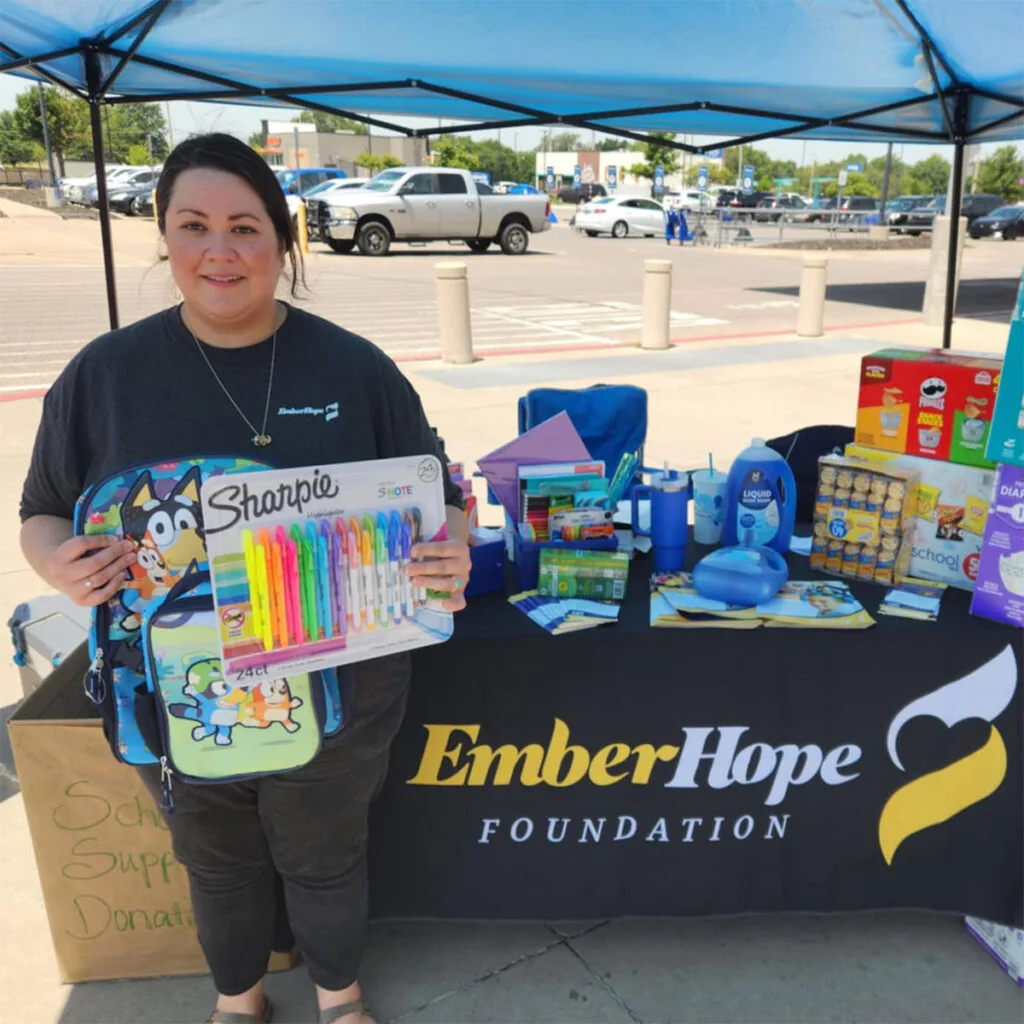 emberhope foundation employee assisting at the school supply drive