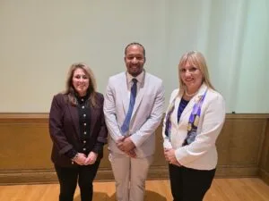 Yusef Presley poses for a photo with EmberHope CEO Nickaila Sandate as well as EmberHope Youthville President Lori Gonzales