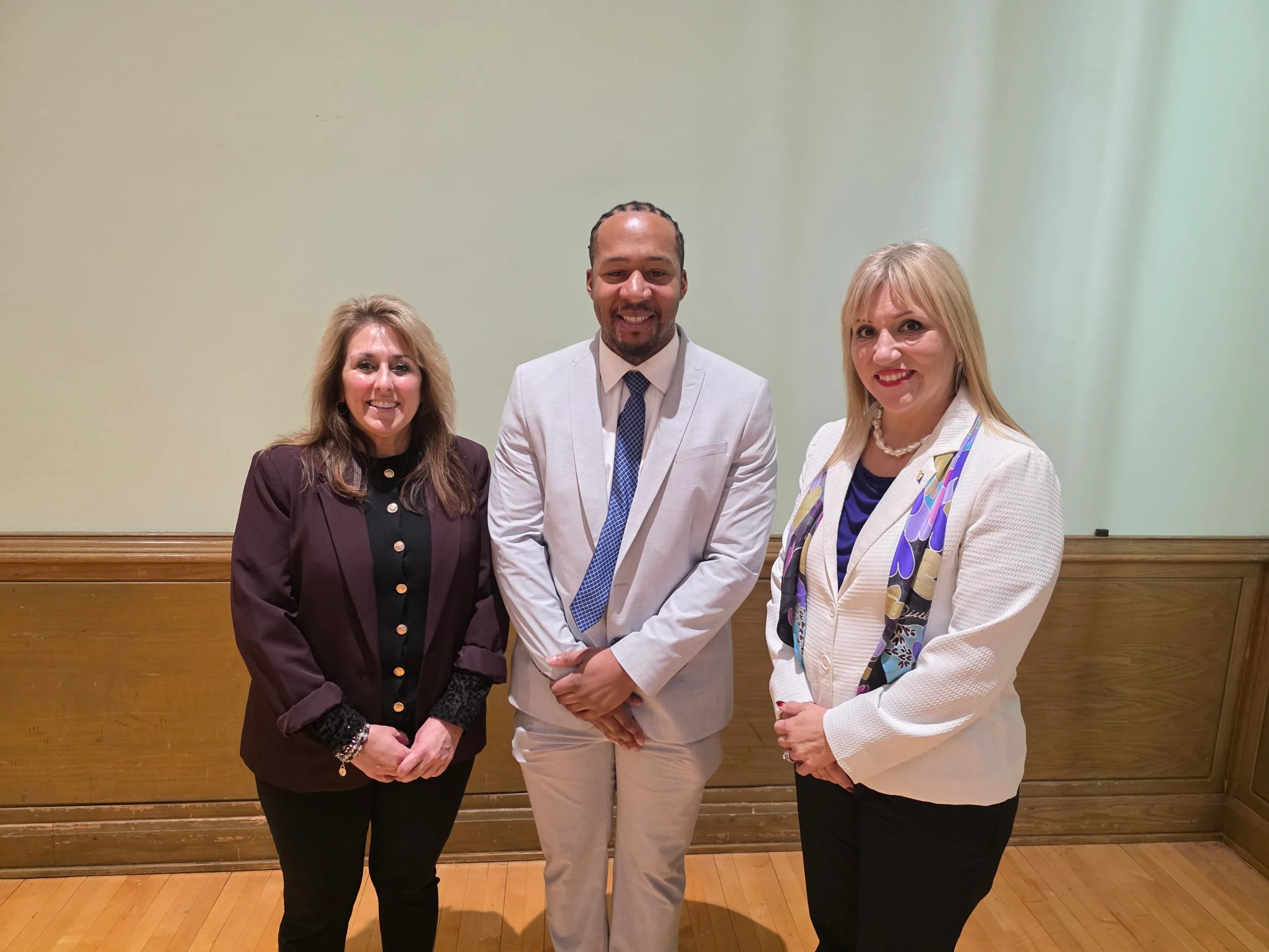 Yusef Presley poses for a photo with EmberHope CEO Nickaila Sandate as well as EmberHope Youthville President Lori Gonzales