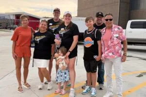 EmberHope staff members and their families standing out in front of Hesston High School before the concert