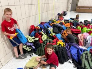 Youth volunteers assisting at the back to school drive