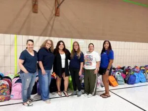 A large group of volunteers at the Back to School Drive