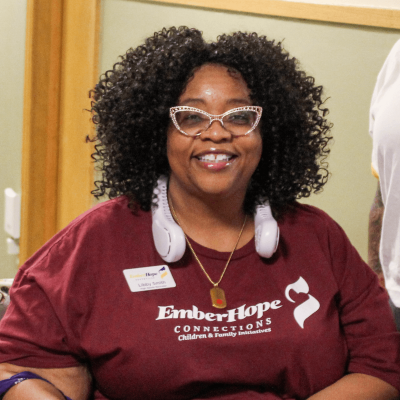 LibbySmith-web Elizabeth Smith, foster care recruiter, sitting at a table